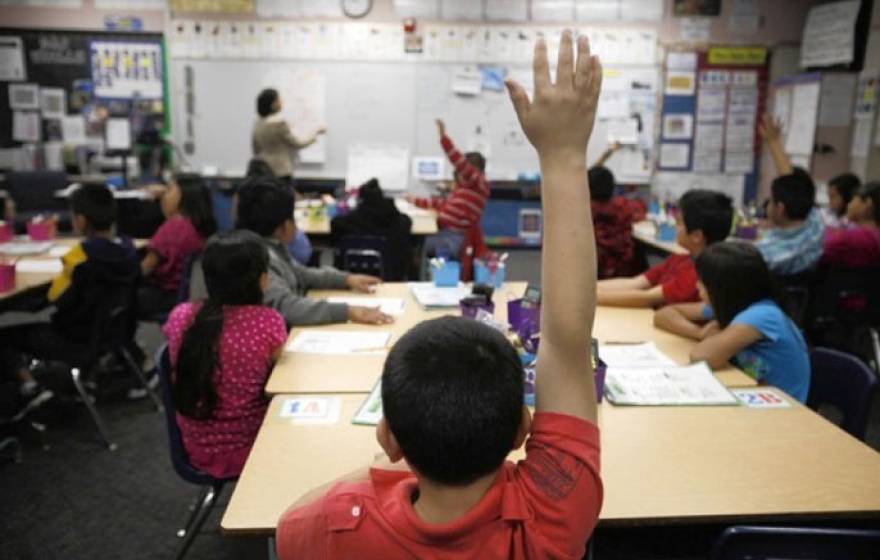 Boy raises hand in classroom Los Angeles Times photo