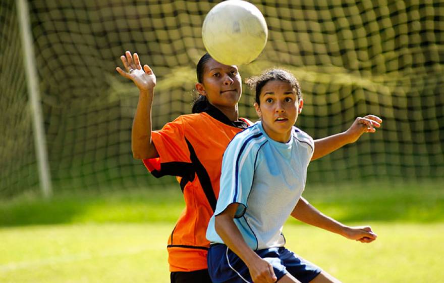 teen girls playing soccer