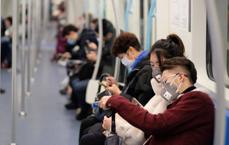 People on a subway with surgical masks on in China