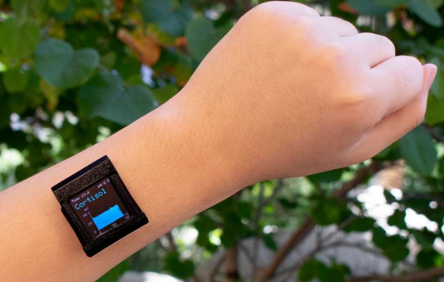 A smart watch on a wrist with cortisol reading displayed