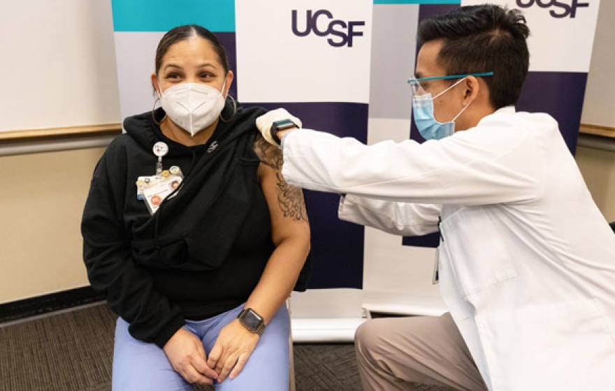 Woman happily getting COVID-19 vaccine