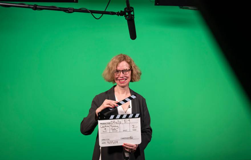 Professor holding a clapperboard