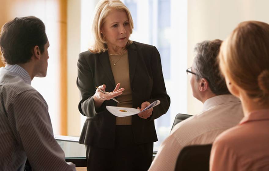 woman executive talks with colleagues