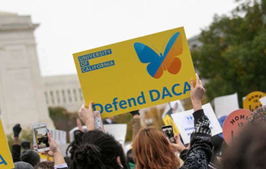 People holding up DACA signs outside SCOTUS