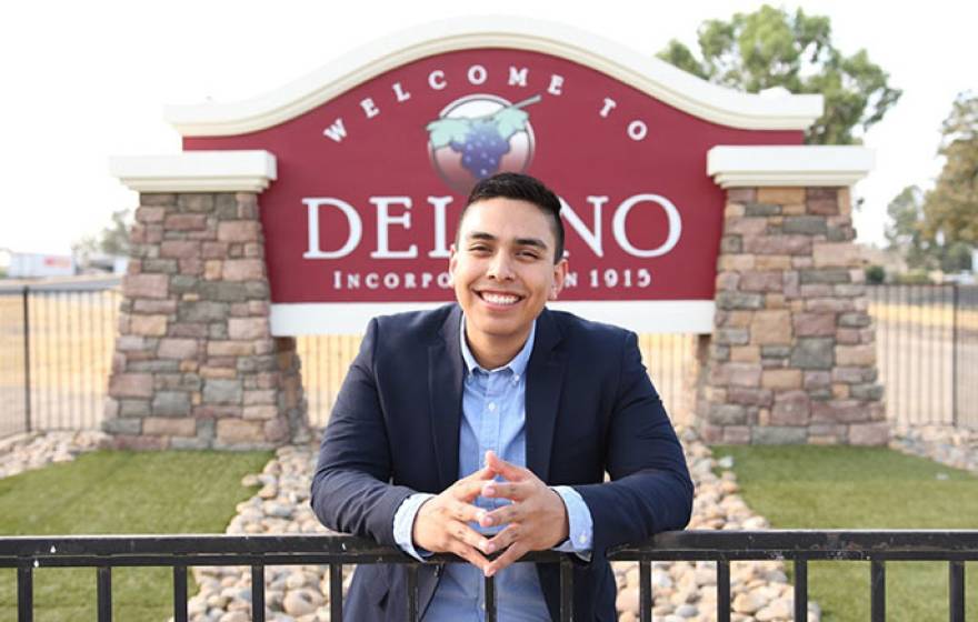 Bryan Osorio Trujillo in front of Delano sign