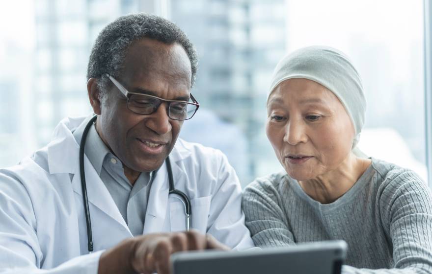 A doctor and a patient look at a screen together