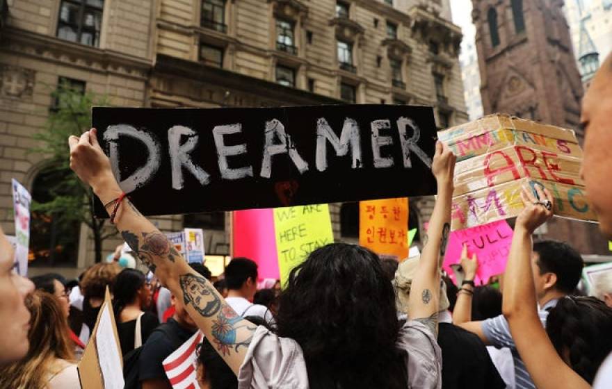 Dreamer supporters holding up signs at a rally