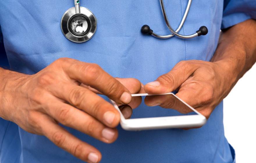 doctor holds smartphone