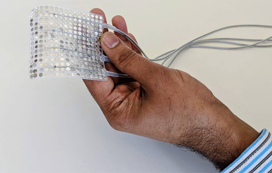 Hand holding the intracranial electrodes of the type used to record brain activity.