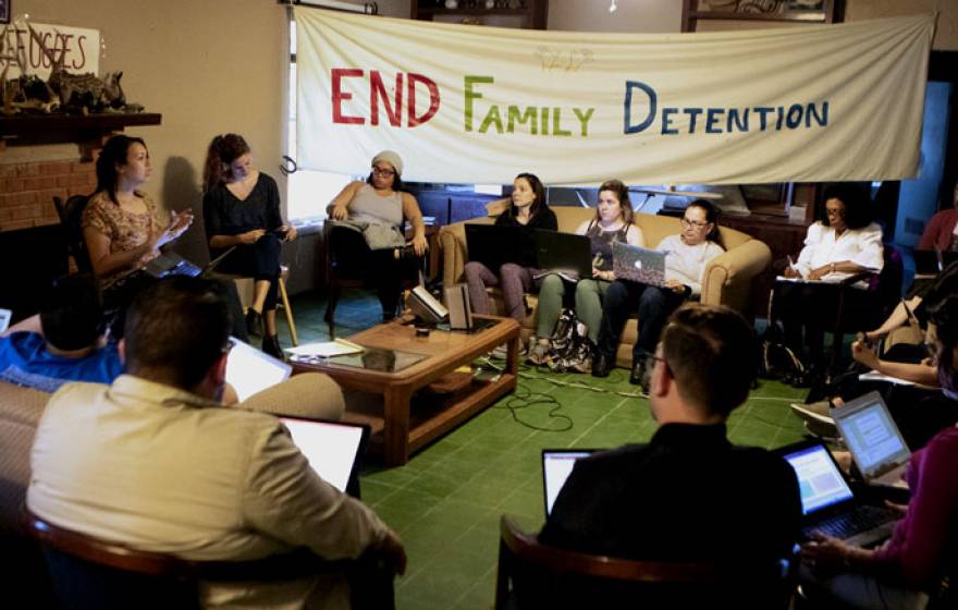A group of people discussing family detention