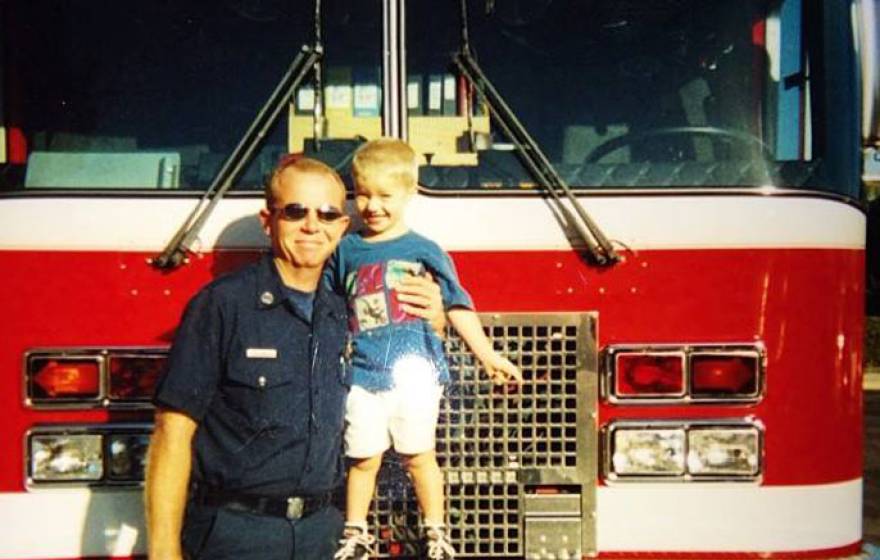 Kelly Richeson in front of fire truck with son