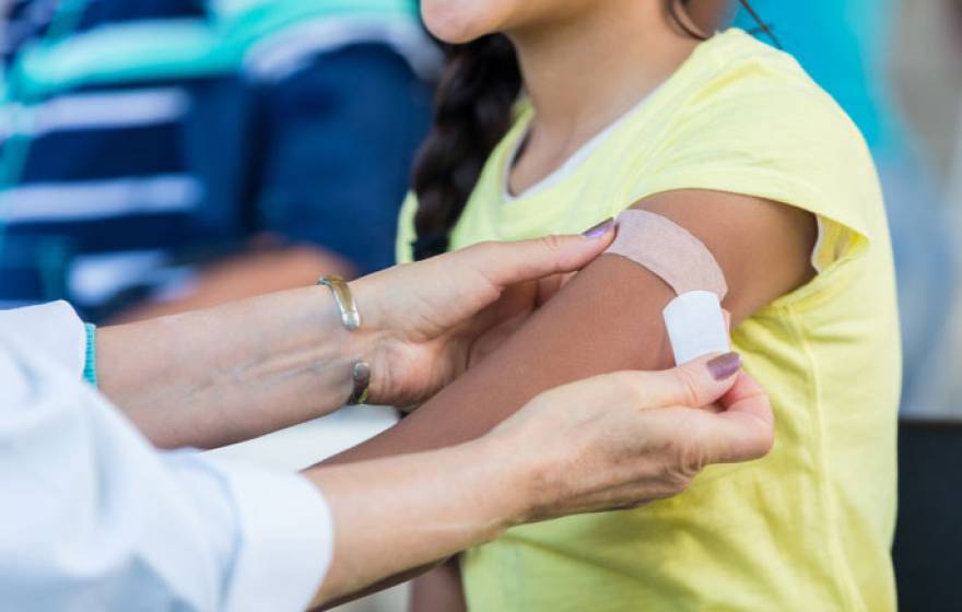 Arm bandaged after getting a flu shot