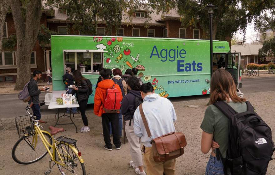 Aggie Eats food truck with students waiting in line