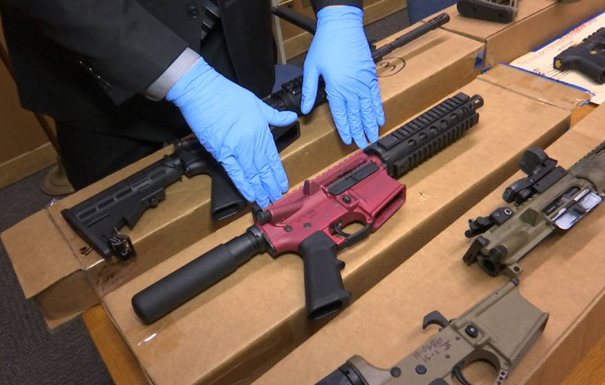 A San Franciso police officer displays several ‘ghost guns’ – untraceable firearms with no serial numbers or manufacturing marks. 