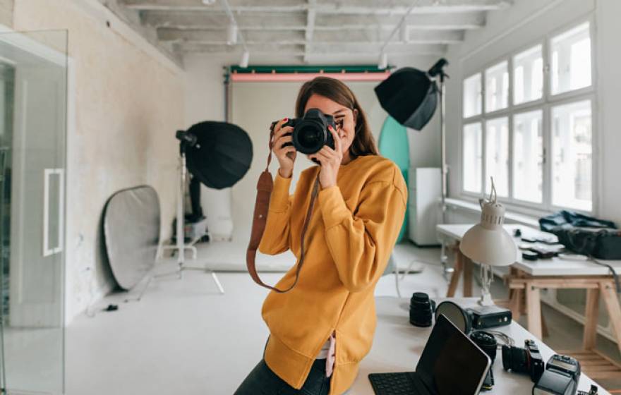 Photographer facing camera with a camera