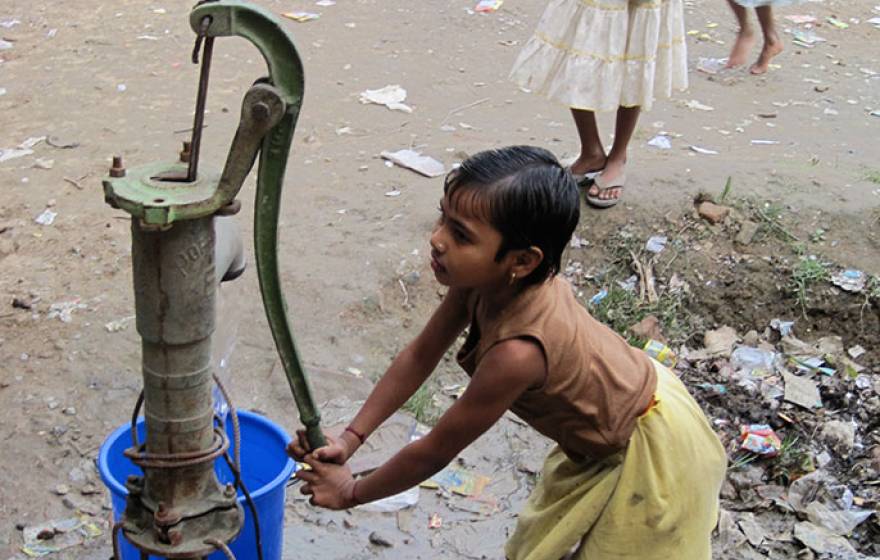 girl at water pump