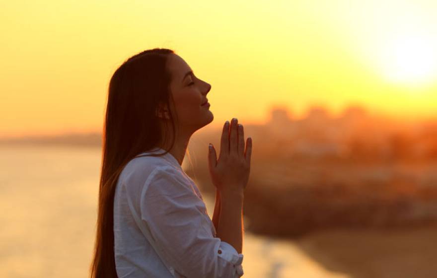 Young woman clasping hands