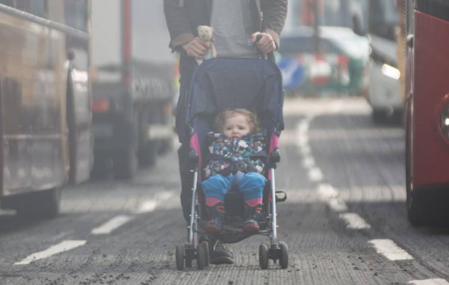 Child in stroller on a smoggy day