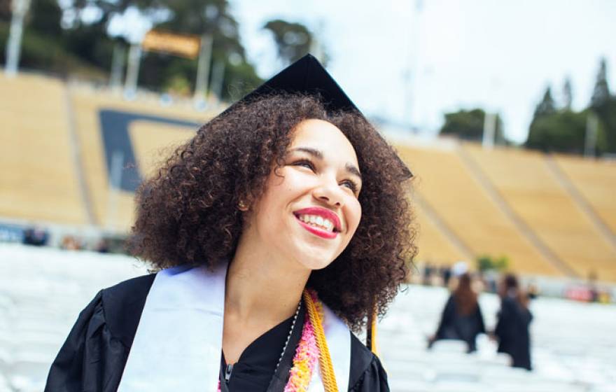 Happy young graduate in a stadium