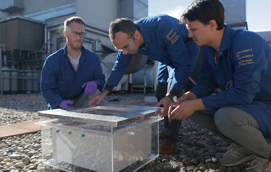 Markus Kalmutzki, Farhad Fathieh and Eugene Kapustin set up the water harvester for tests on a rooftop on the UC Berkeley campus