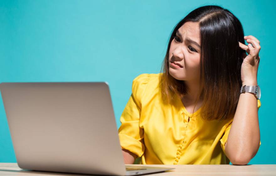 Woman reading fake news on her laptop