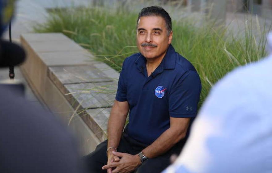 José Hernández sitting outside in a NASA polo