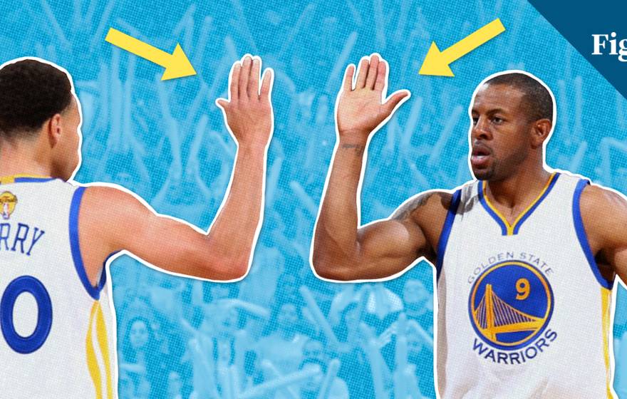 Two basketball players do a high-five