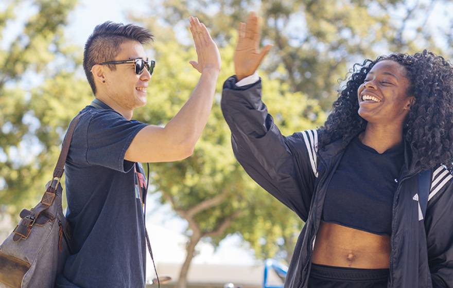 Two UC Davis students do a high-five
