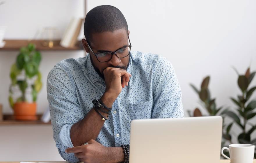 Man anxiously looks at his laptop