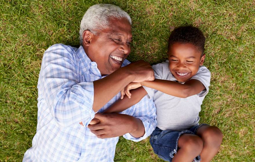 Aerial view of grandfather and grandson playing together on grass