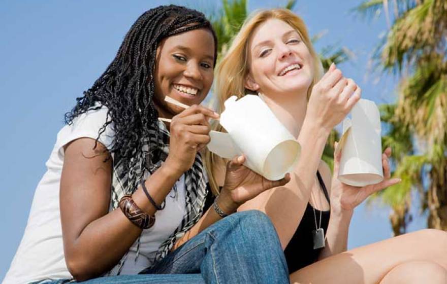 Young women eating Chinese takeout food (iStock)