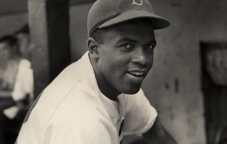 Jackie Robinson smiles in his Brooklyn Dodgers uniform