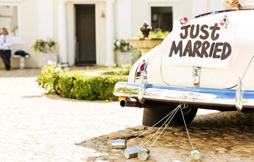 Just married old car in a sunny square