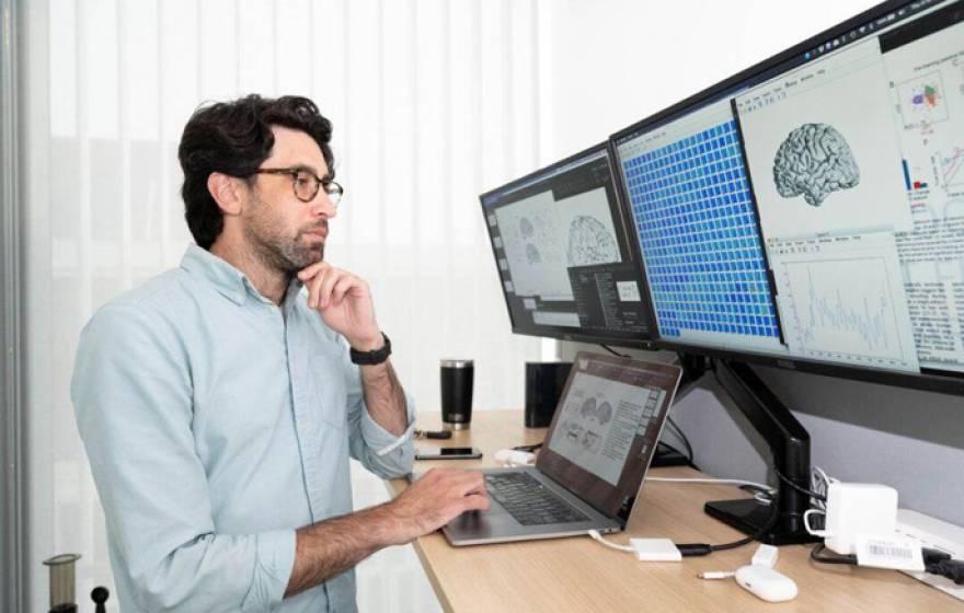 Matt Leonard looking at computer screens