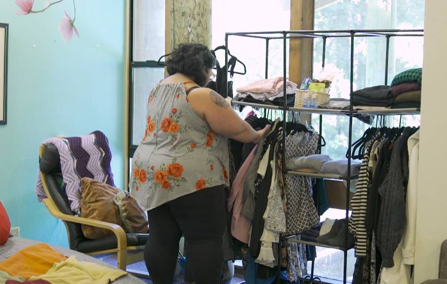 Trying on clothes at the Cantu Clothing Closet