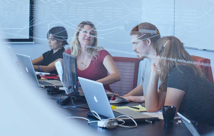 several people in a conference room working