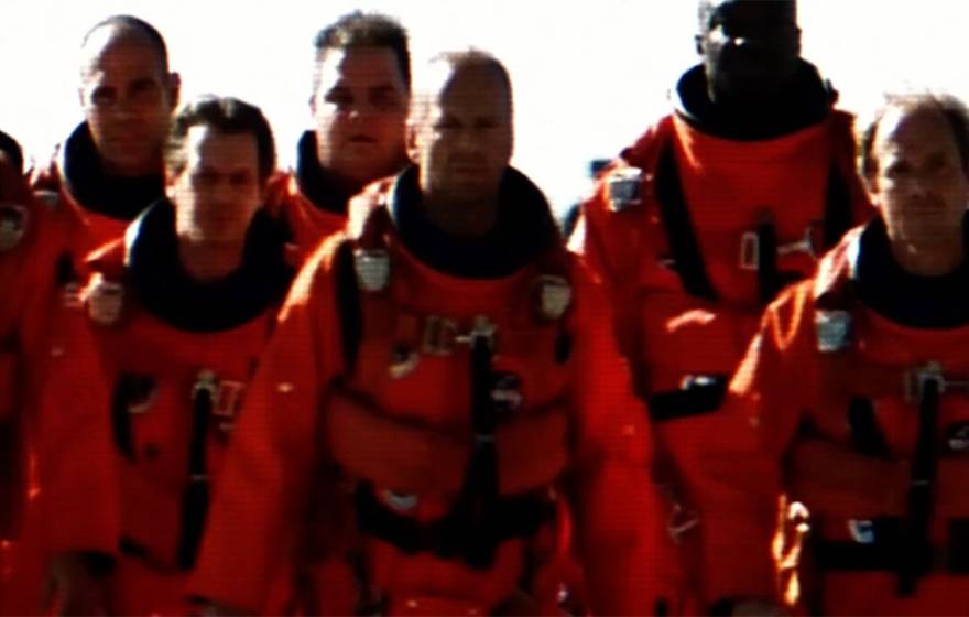 Bruce Willis and cast of Armageddon walking in spacesuits