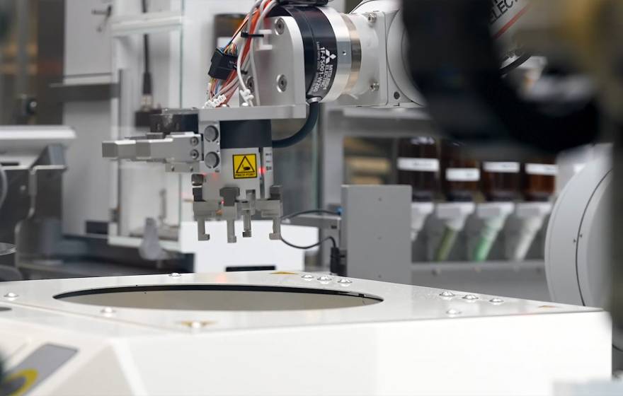 A robot arm grabbing samples to process in Berkeley Lab