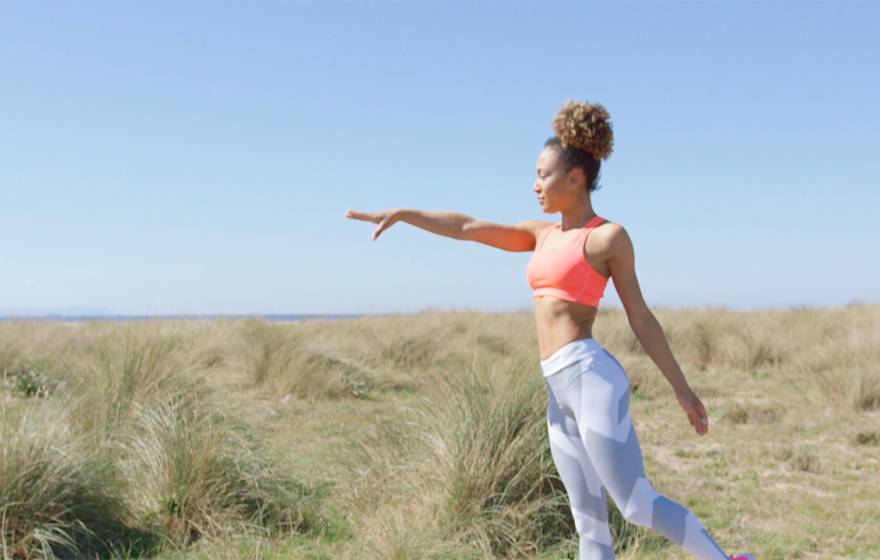 A woman doing yoga outdoors