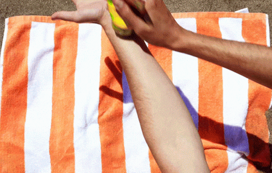 Putting suntan lotion on