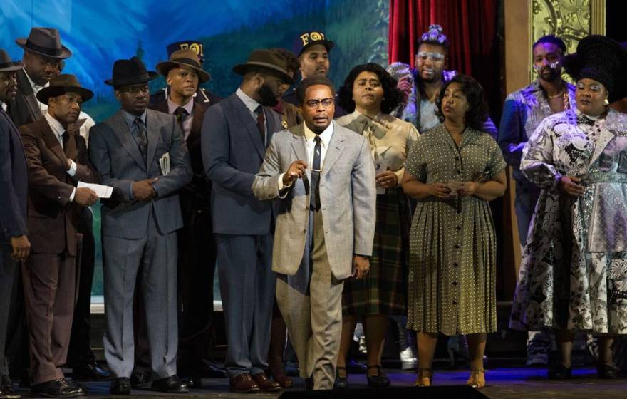 The cast of "X: The Life and Times of Malcolm X" on stage at the Metropolitan Opera, in 1950s era costuming