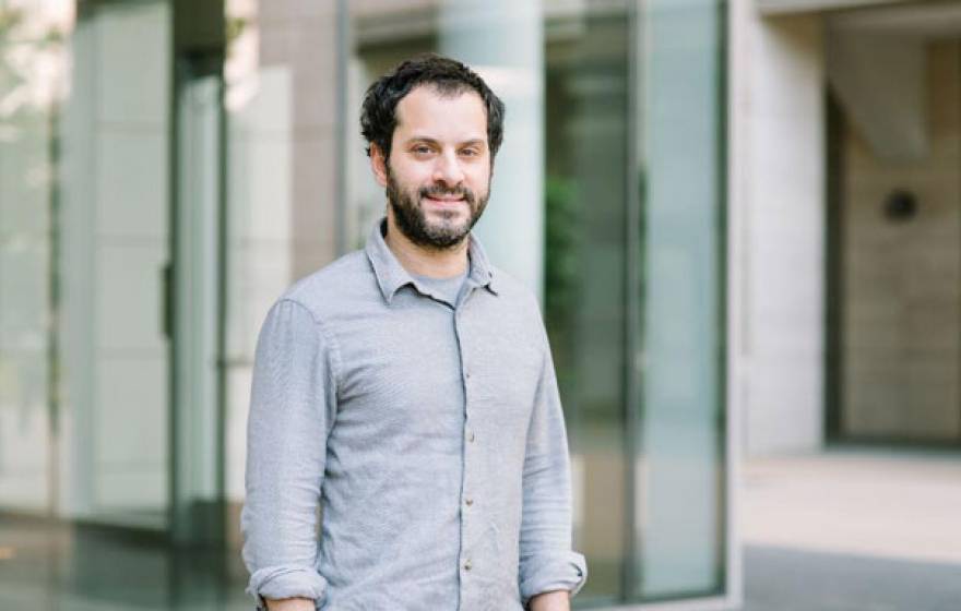 Mazen Kheirbek stands in front of a building