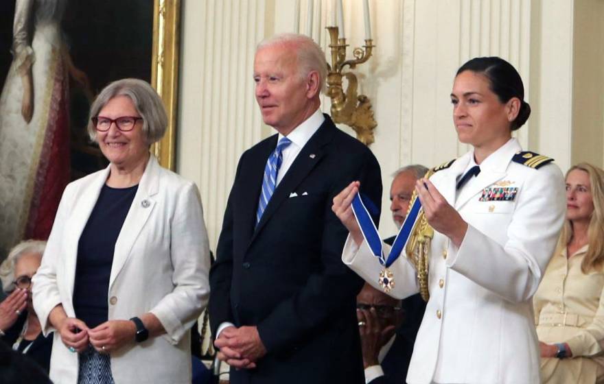 Sister Simone, President Biden and a woman in a Navy officer holding the Presidential Medal of Freedom