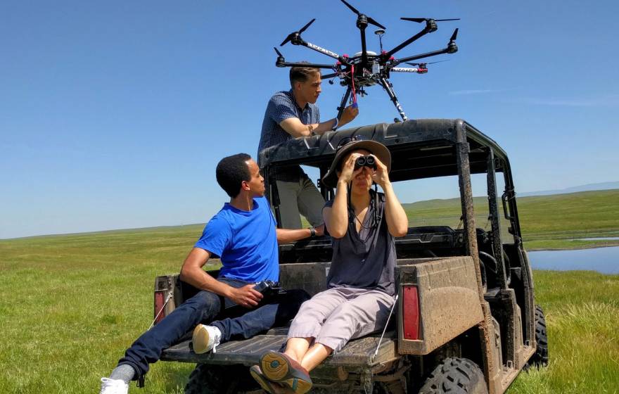 UC Merced engineering students in a field on a jeep
