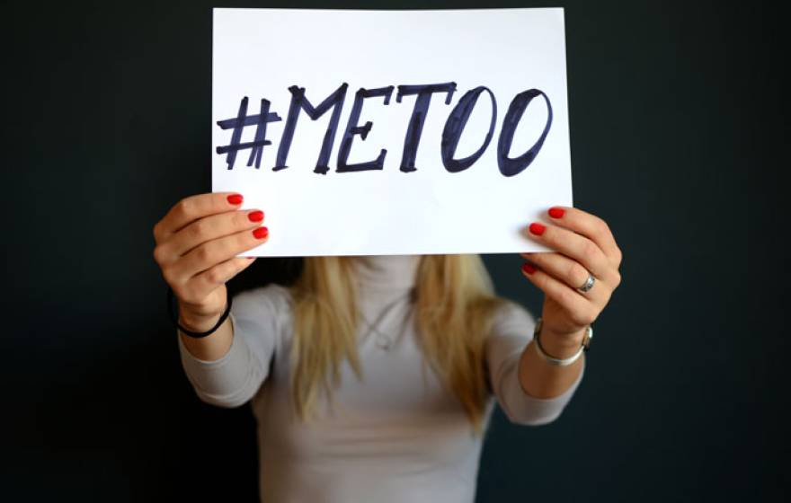 Hands holding up a #MeToo sign