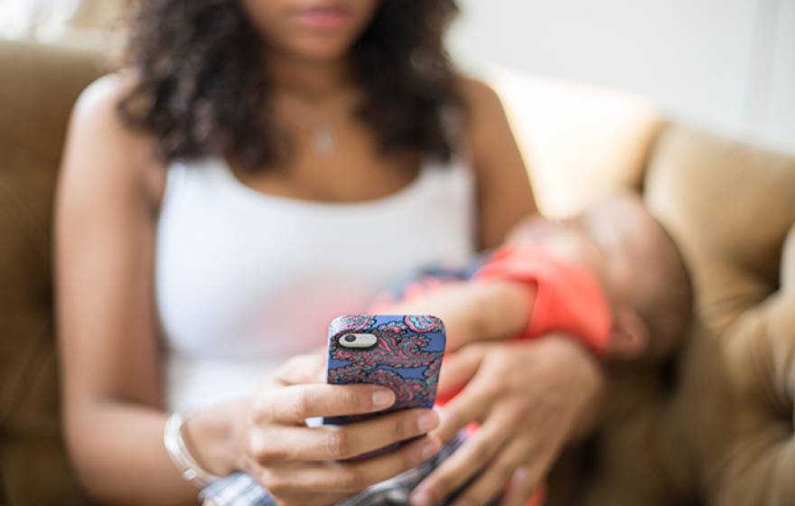 Mother with baby and cellphone