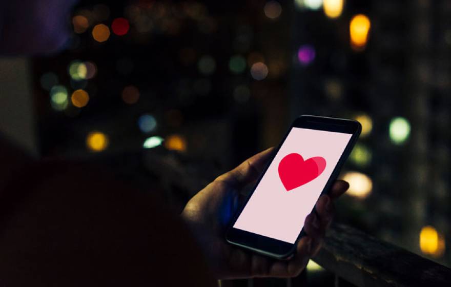 A phone with a heart on it at night