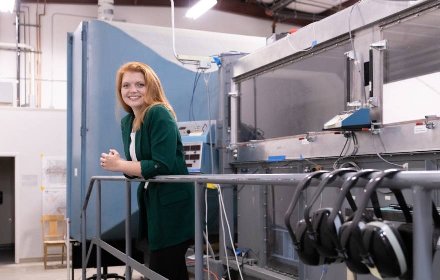 Young woman with red hair and a green cardigan in a laboratory