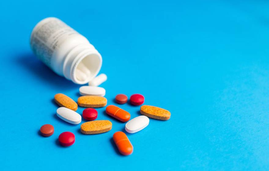 Pills bottle blue background