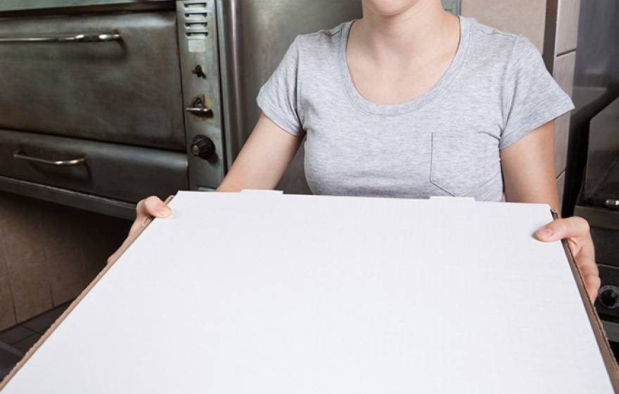 young woman working at pizza parlor